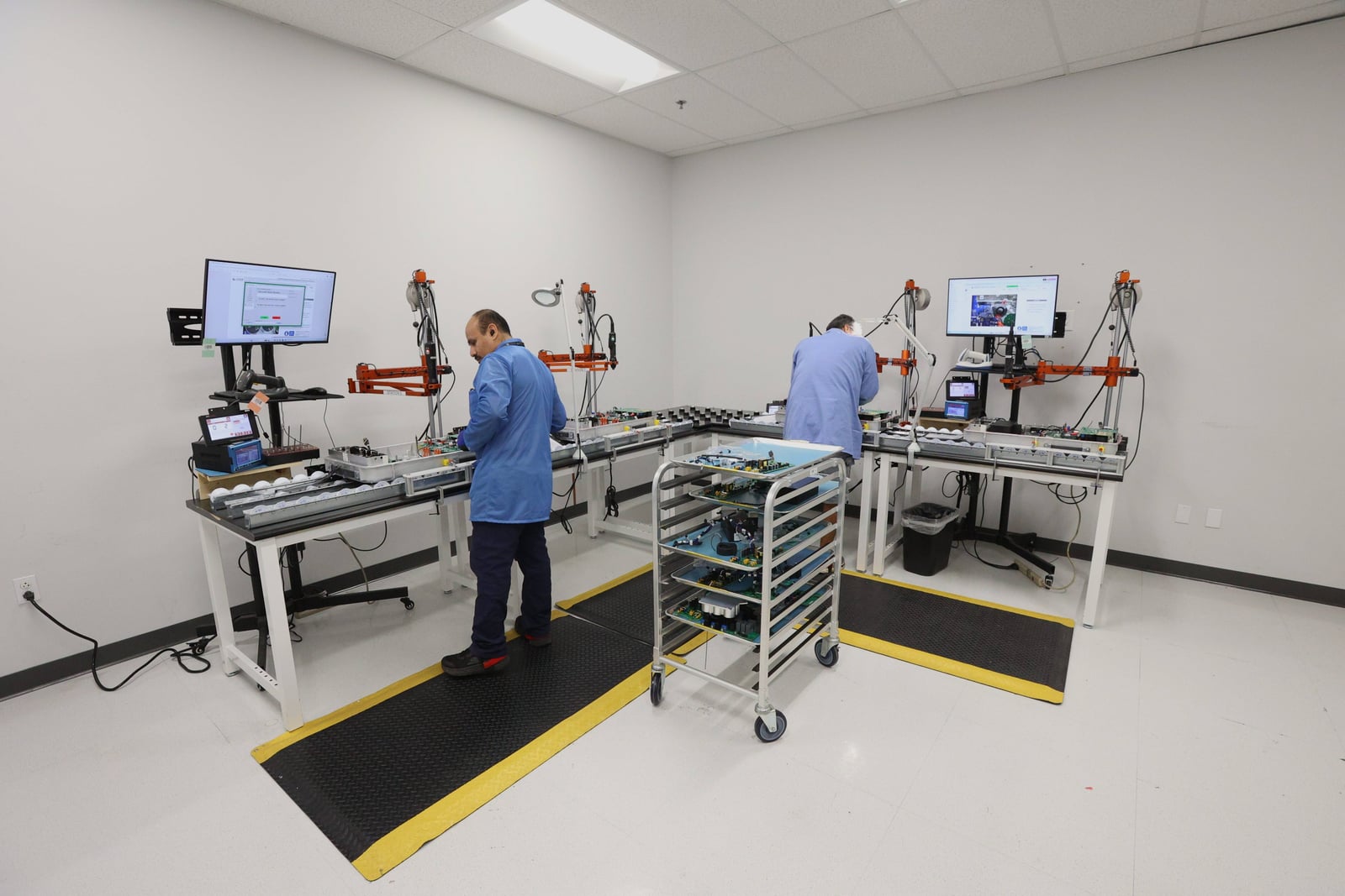 Technicians working at assembly stations in the Carlsbad facility